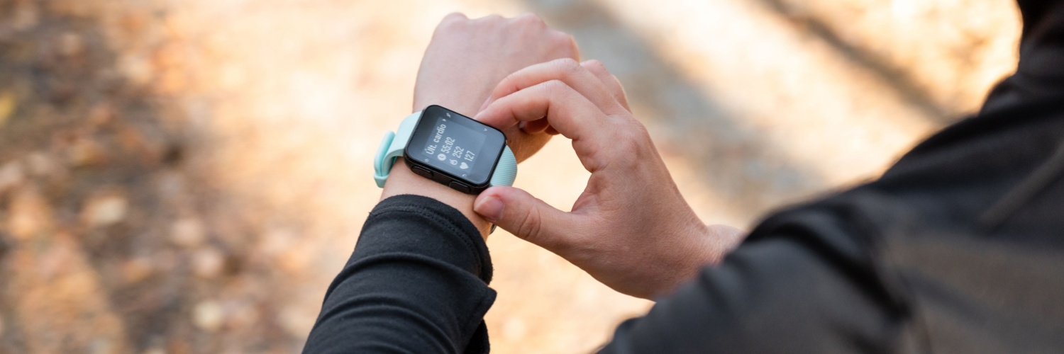 A runner looking at the time on their watch.
