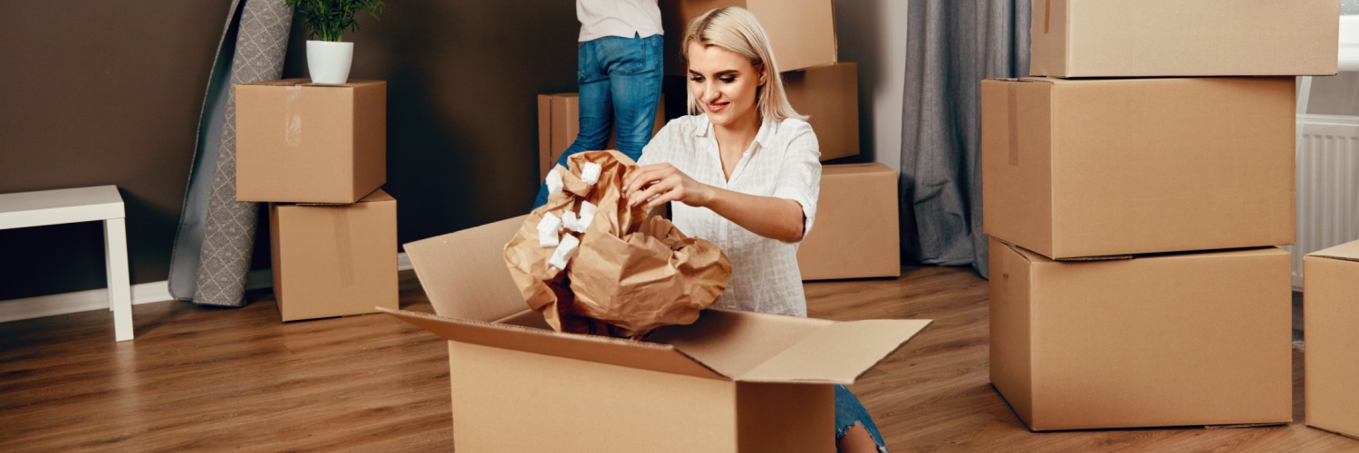 A couple unpacking boxes after moving home.