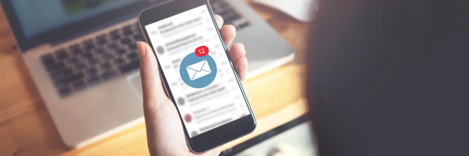 A person looking at their email on their phone.